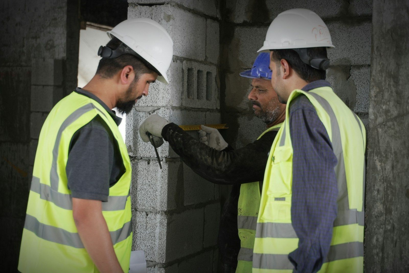Site engineers in hard hats reviewing works on site